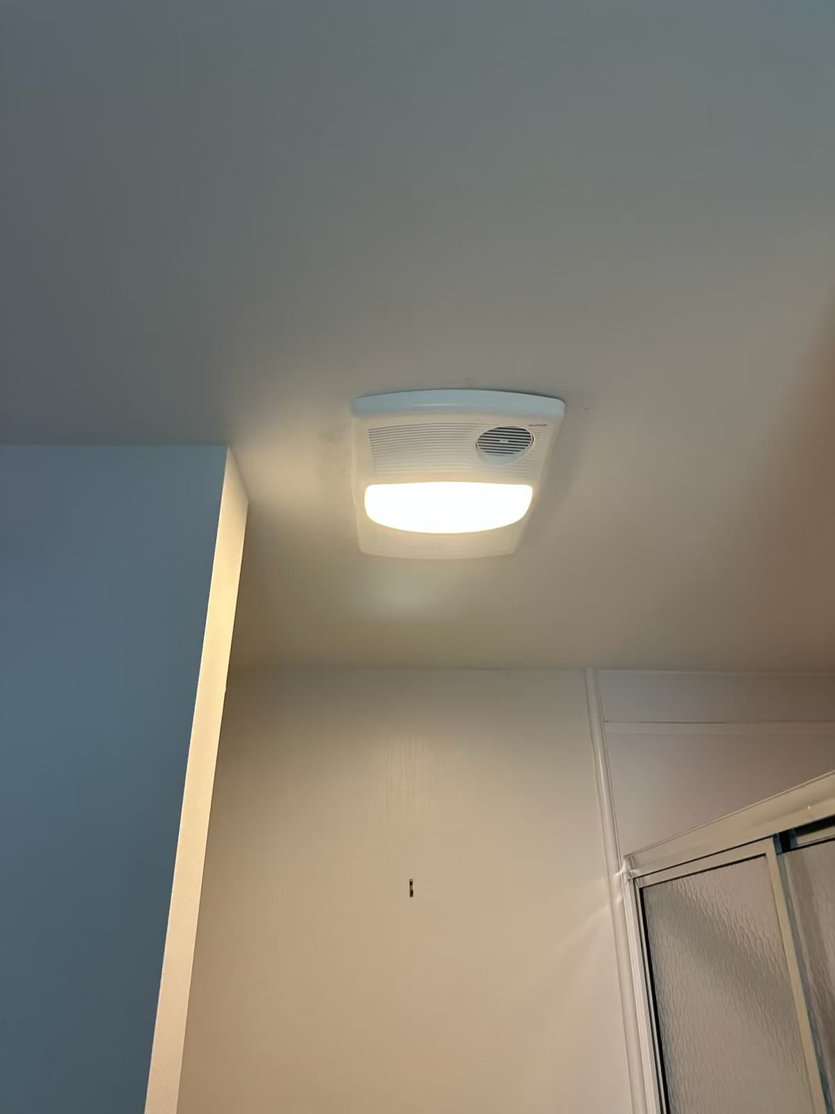 Second bathroom ceiling unit with its light illuminated on the Christiansburg job